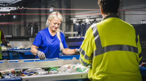 twee vrouwen doen het laatste sorteerwerk in de kunststofsorteerinstallatie